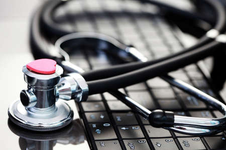 close-ups of laptop and stethoscope as a medical helpの写真素材