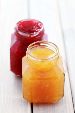 jar of orange and raspberry jam - food and drinkの写真素材