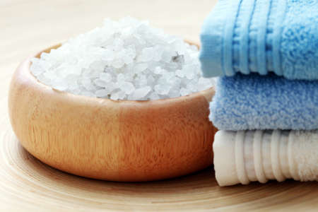 bowl of aromatic bath salt and pile of towels - beauty treatmentの写真素材