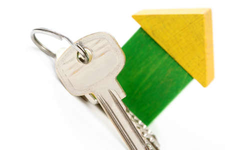 wooden house and keys isolated on whiteの写真素材