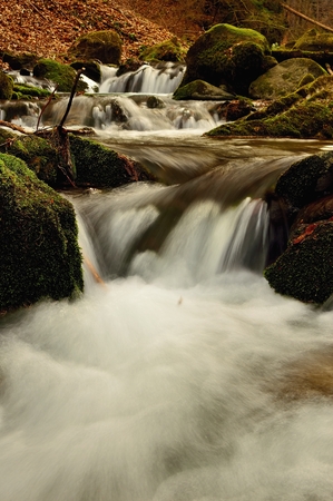 Spring flowing mountain stream waterfall in Slovakiaの写真素材