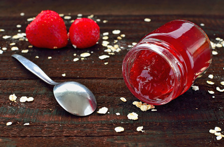 Strawberry jam on wooden table. Season fruit home made marmalade. Healthy strawberries and oatmeal