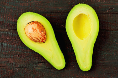 Fresh avocado isolated on wood table background. Tasty and vegetable health. Exotic fruit.の写真素材