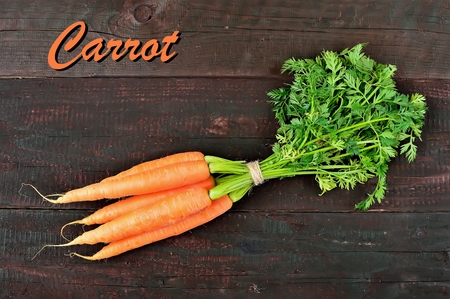 Fresh carrot packet on wood table background. Tasty and health product. Root vegetableの写真素材
