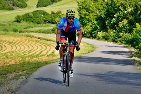 BANSKA BYSTRICA, SLOVAKIA - JUNE 08, 2017: Cyclists rising to the top of the hill on second stage of road cycling championship - Tour of Slovakiaのeditorial素材