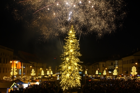 BANSKA BYSTRICA, SLOVAKIA - JANUARY 1, 2017: New Year`s Eve firework behind Christmas tree. Celebrating 2017 in Banska Bystrica, Slovakia. Multicolor explosion on dark sky. Foundation day of Slovak republicのeditorial素材
