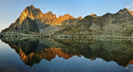 Sunrise in High Tatras in Slovakia. Monumental peak Prostredny hrot. Summer scenic landscape...
