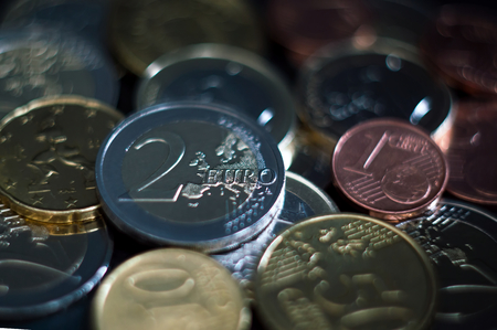 Various euro coins. Stacked euro coins of different values on gray background.の写真素材