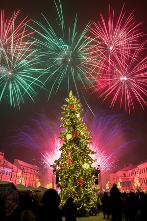 BANSKA BYSTRICA, SLOVAKIA - JANUARY 1, 2019: New Year`s Eve firework behind Christmas tree. Celebrating 2019 in Banska Bystrica, Slovakia. Multicolor explosion on dark sky. Foundation day of Slovak republicのeditorial素材