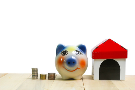 piggy bank and on wood white backgroundの写真素材