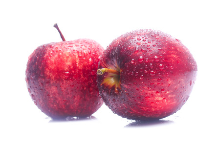 wet Red apple isolated on white backgroundの写真素材