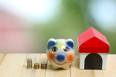 coin piggy bank on wood and  bokeh background concept save moneyの写真素材