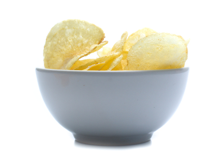 Potato chips on bowl isolated on whiteの写真素材