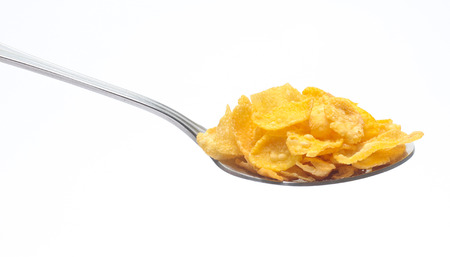 Cornflakes on spoon  isolated on white backgroundの写真素材