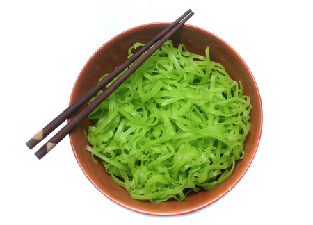 green noodles on bowl isolated on white backgroundの写真素材