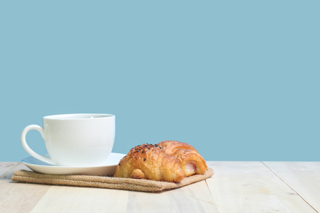 Croissant and coffee   on wood tableの写真素材