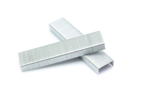 metal staple concept over white background