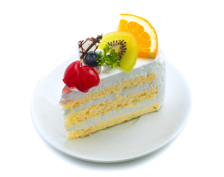 cake with cream and cherry orange blueberry isolated on white backgroundの写真素材
