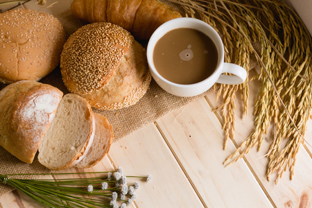 bread and wheat on white wood background with copy spaceの写真素材