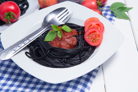 Spaghetti pasta with and tomato sauce on wood backgroundの写真素材