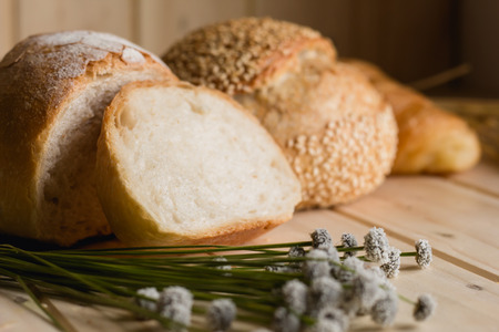 bread and wheat on white wood background with copy spaceの写真素材