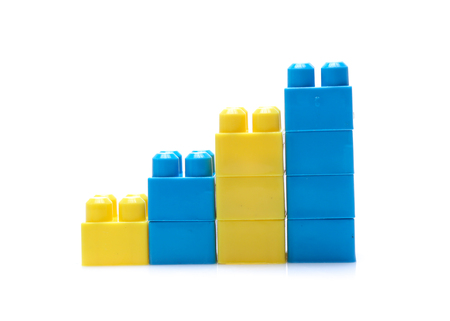 Colorful stacked toy plastic building blocks isolated on white backgroundの写真素材