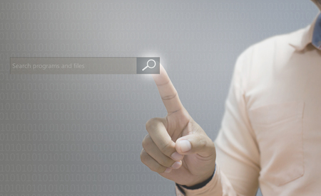 Technology  searching system and internet concept  man hand pressing Search buttonの写真素材