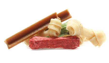 bones and colorful sticks for dog treat with vitamin and oral health on white backgroundの写真素材