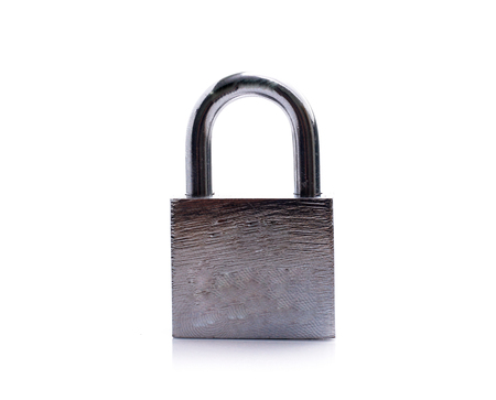 Metal padlock with keys on a ring isolated on whiteの写真素材