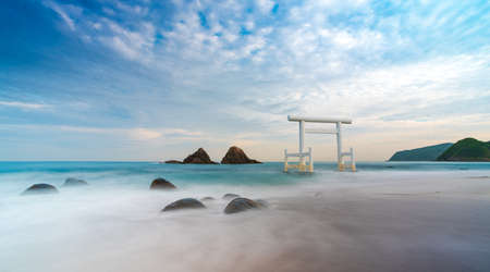 itoshima, japan - april 24 2021: Sakurai Futamigaura's sacred Couple Stones and torii view from de beachのeditorial素材