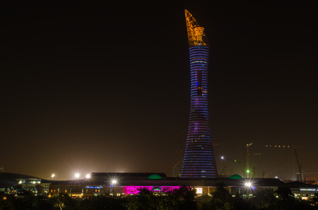 The Aspire Park and Aspire Tower or Torch Hotel in Doha Sports City at nightのeditorial素材