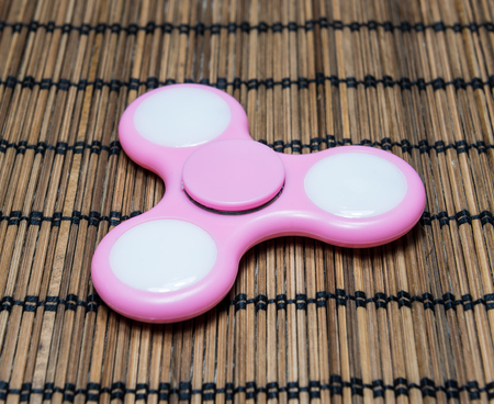 Fidget spinner on bamboo matの写真素材