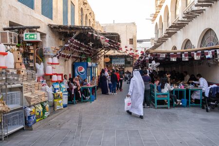 Tourist and local at Souq Wakif. Souq Waqif is a main marketplace and a popular tourist attraction selling traditional garments, spices, handicrafts, and souvenirs.のeditorial素材