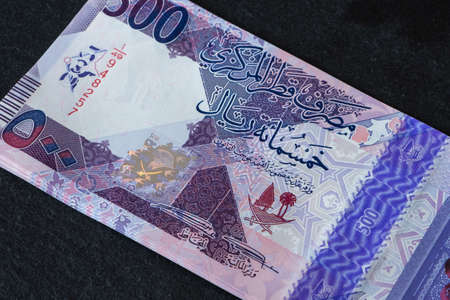 New Qatari Riyal banknotes on black background