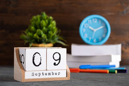 September 09th. September 09 wooden cube calendar with blur objects on background.の写真素材