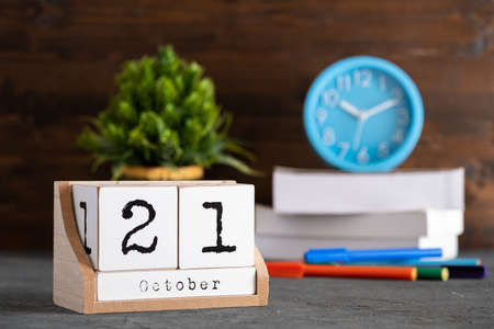 October 21st. October 21 wooden cube calendar with blur objects on background.の写真素材