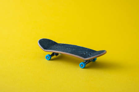 Mini skateboard on yellow backgroundの写真素材