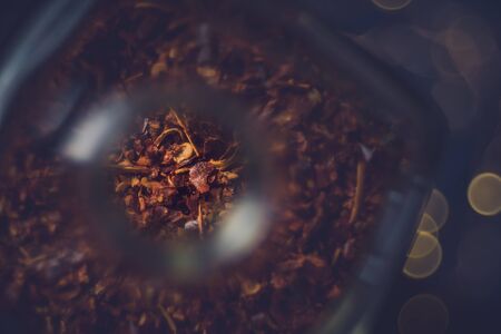 top view of a bottle filled with chili layered on a dark background. bokeh light in the background. close-upの写真素材