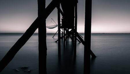 from behind view of a fishing hut on stilts called Carrelet. black and white and long exposure photographyの写真素材
