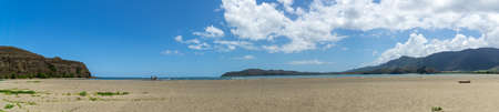 Panorama of new caledonia beach at Poe on a sunny day. Sky is blue with white clouds. Turtle bay on...