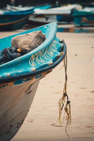 detail of a white and blue fishing boat on the beach. old rope on the prow, Arugam bay, Sri lankaの写真素材