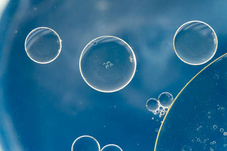 Oil drops on the water - Abstract background blue macro photographyの写真素材