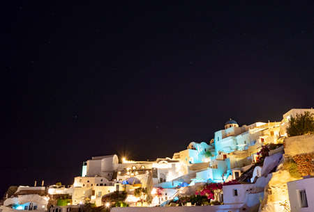 Night falling on the Greek village of Oia on the island of Santorini. typical orthodox church...