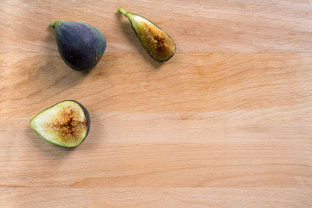 Fresh figs on a wooden table. Free space for text. Top view.