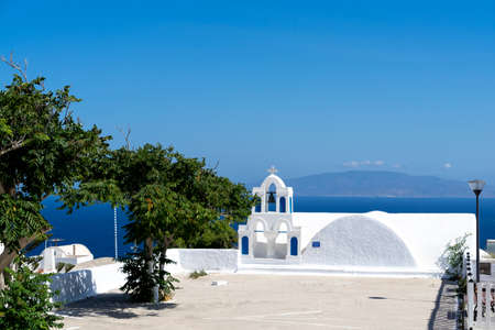 Typical detail of a bell tower of an orthodox white church in the village of Oia, santorini, cyclades, Greece.の写真素材
