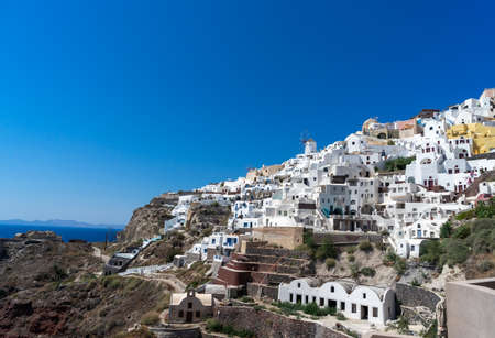 Panoramic view of Oia town in Santorini island with old whitewashed houses and traditional windmill, Greece Greek landscape on a sunny dayの写真素材