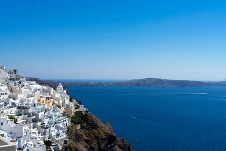 Panoramic view of Thira town in Santorini island with old whitewashed houses and typical orthodox church, Greece Greek landscape on a sunny dayの写真素材