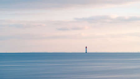 Beautiful minimalist seascape at sunset with Chauveau lighthouse. Rivedoux, Re Island, Franceの写真素材