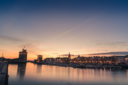 Panoramic view of the old harbor of La Rochelle at blue hour with its famous old towersのeditorial素材
