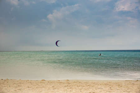 A kitesurfer surfing near the beach in Maldivesの写真素材